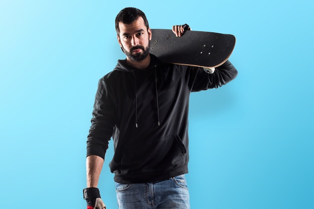 Man with his skate on colorful background