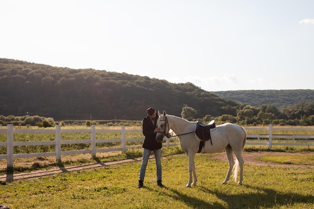 Man with a horse on a background of beautiful nature