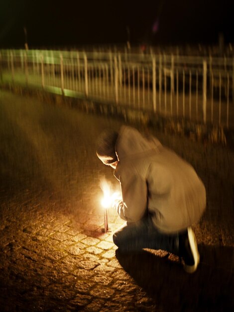 Man with horse in background at night