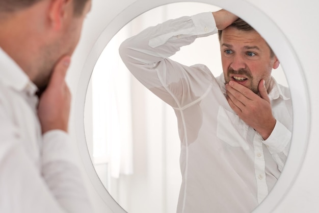 Photo man with hyperhidrosis sweating very badly under armpit