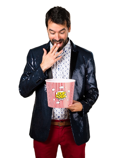 Man with jacket eating popcorns