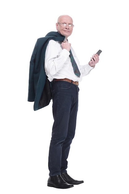 Man with a jacket over his shoulder reading a message on his smartphone