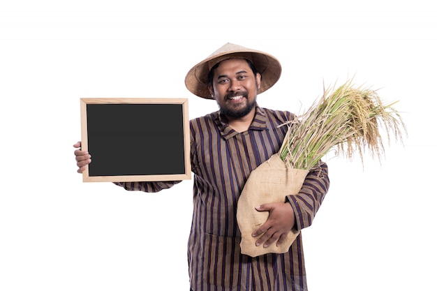 Man with Javanese shirt holding rice grains