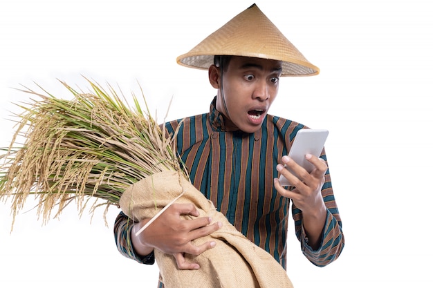 Man with Javanese shirt holding rice grains