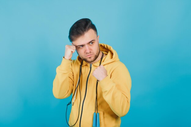 a man with a jump rope on a blue background