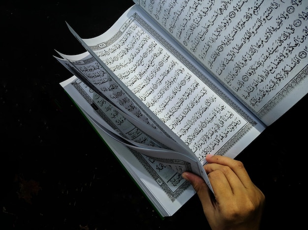 Man with Koran holy book of Muslims