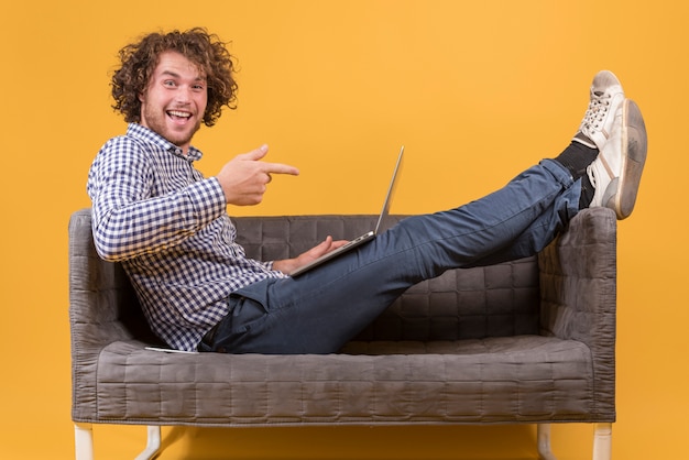 Man with laptop on couch