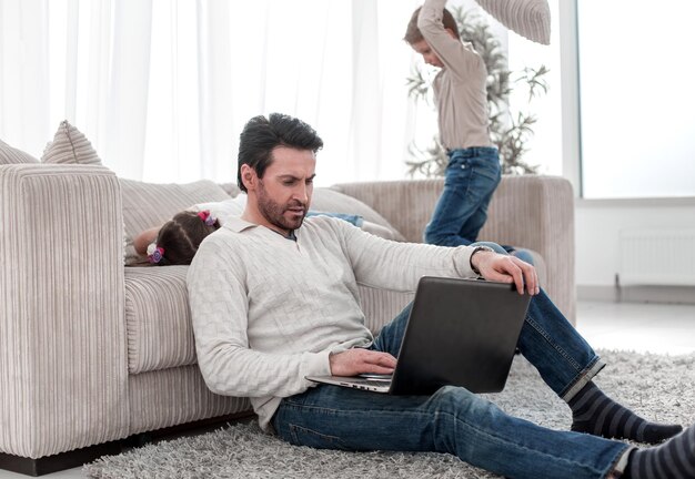 Man with a laptop sitting in the living room people and technology