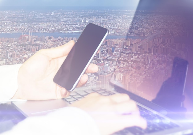 Man with laptop and smartphone