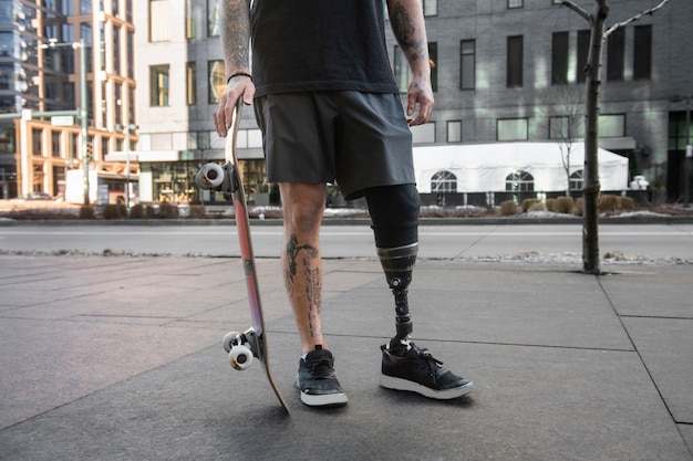 Man with leg disability skateboarding in the city