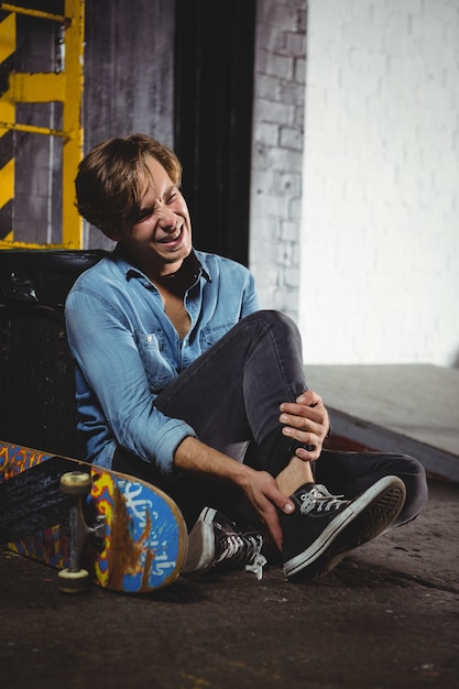 Man with leg injury sitting