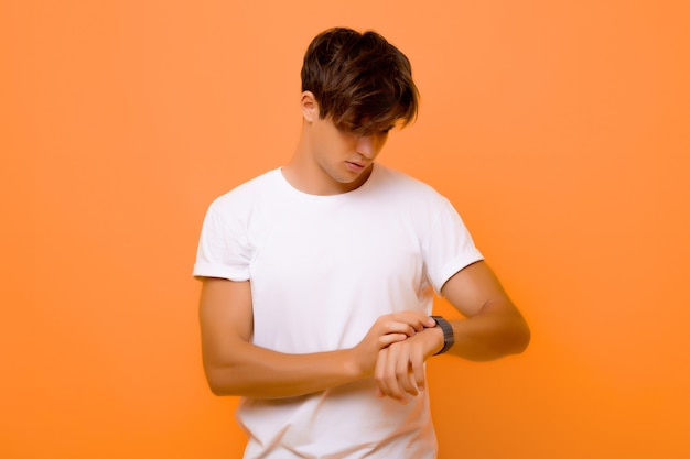 man with long hair looking at his watch.