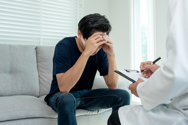man with mental health problems is consulting psychiatrist is recording the patient's condition for treatment encouragement love and family problem bipolar depression patient protect suicide