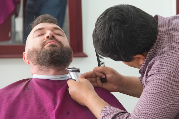 A man with a mohawk and beard in the barbershop