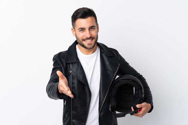 Man with a motorcycle helmet handshaking after good deal