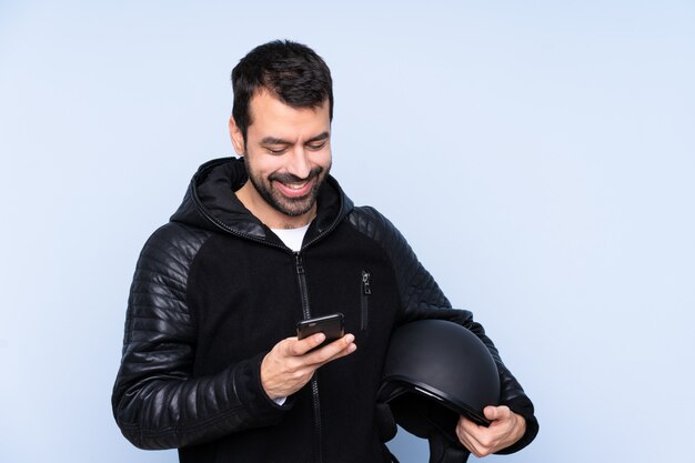 Man with a motorcycle helmet over isolated wall