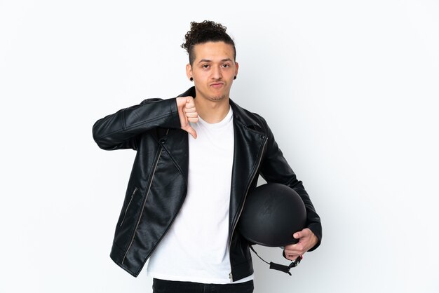 man with a motorcycle helmet over isolated white showing thumb down sign