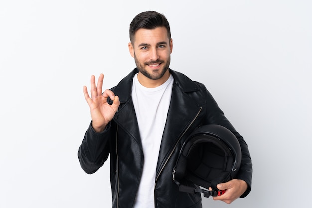 Man with a motorcycle helmet showing an ok sign with fingers