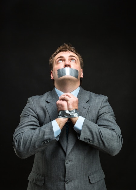 Man with mouth covered by masking tape