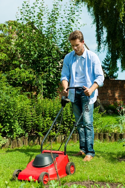 Man with mowing machine in his backyard