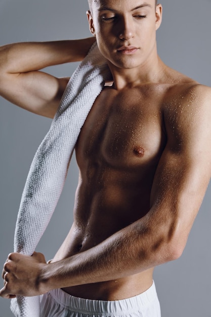 Man with muscular body closeup workout towel