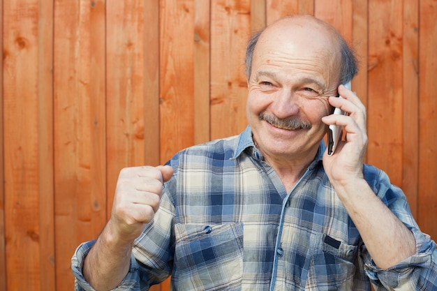 Man with mustache talking on mobile phone