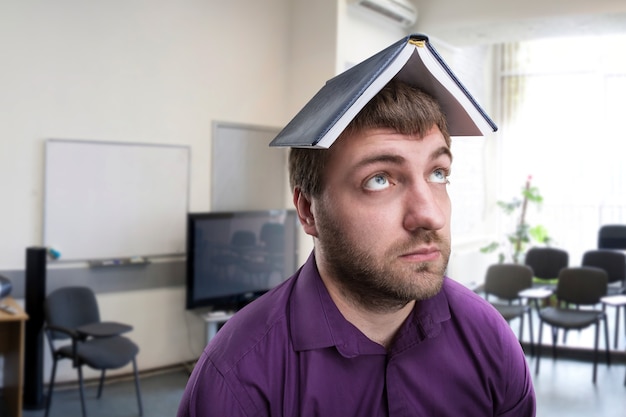 Man with notebook on his head