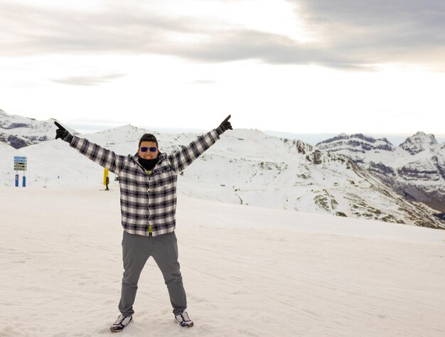 Man with open arms in the snow