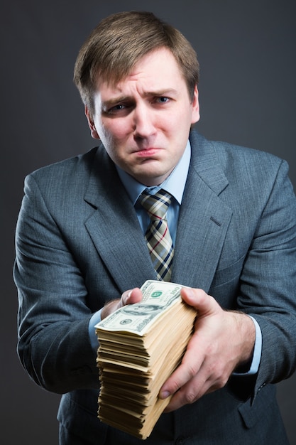 Man with pack of money  isolated on gray