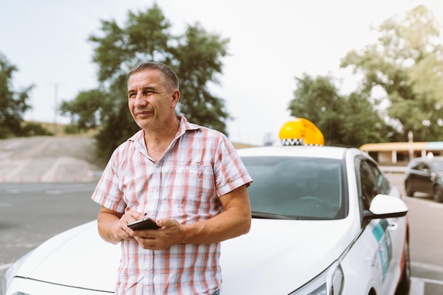 man with phone near taxi