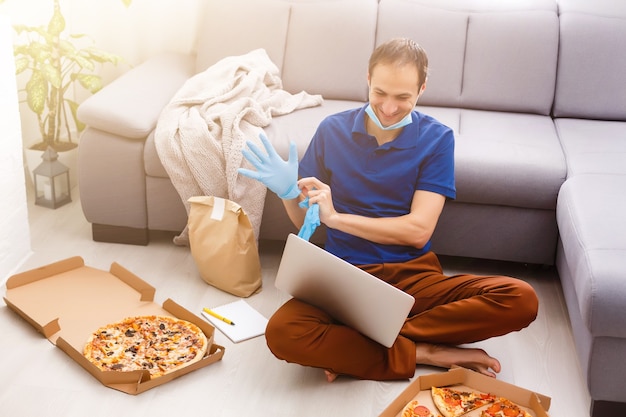 man with pizza at home during quarantine