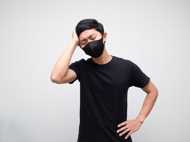 Man with protect mask feeling headache touch his head serious face white background