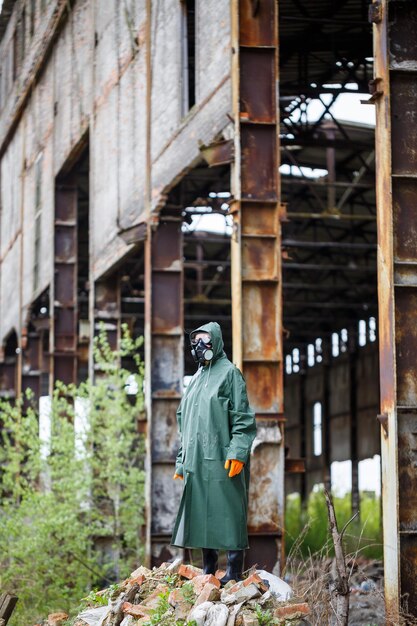 A man with a protective mask and protective clothing examines\
the danger zone ecological catastrophe dangerous toxic zone