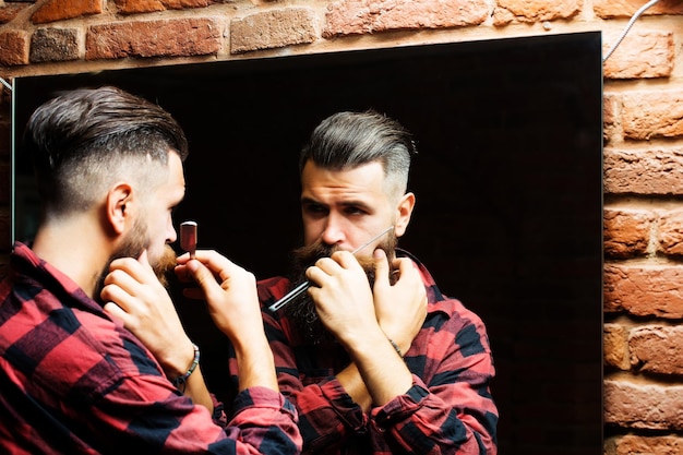 Man with razor near mirror