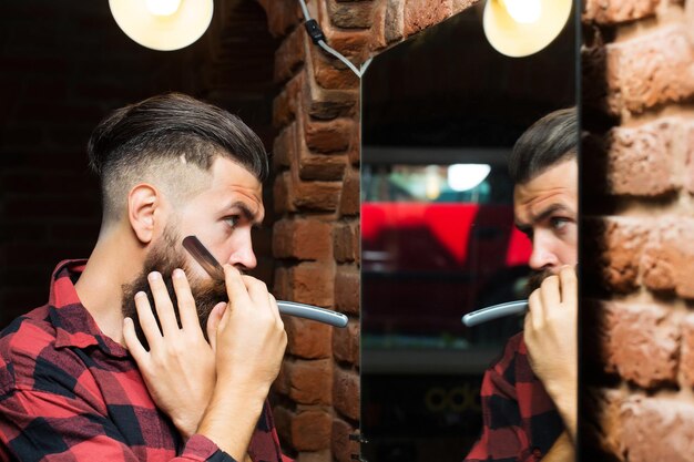 Man with razor near mirror