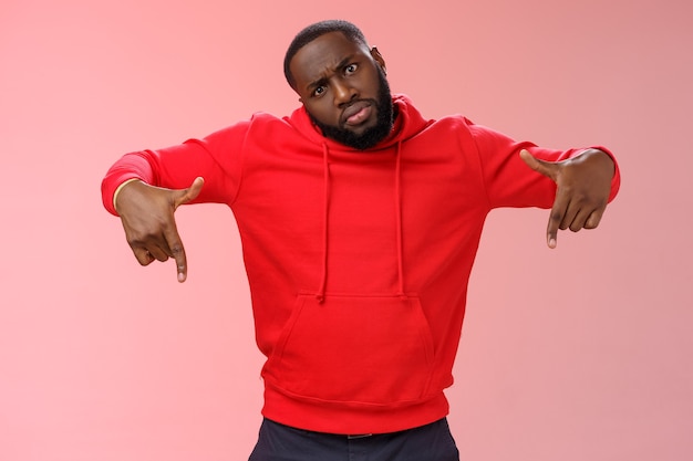 Man with a red sweatshirt over pink