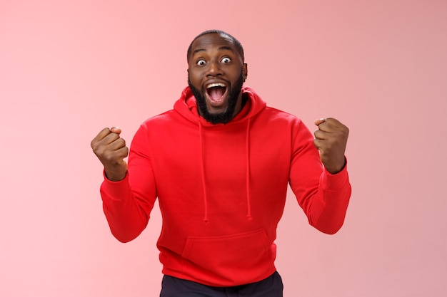 Man with a red sweatshirt over pink