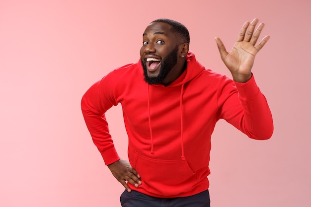 Man with a red sweatshirt over pink