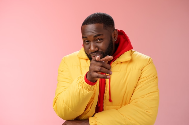 Man with a red sweatshirt over pink