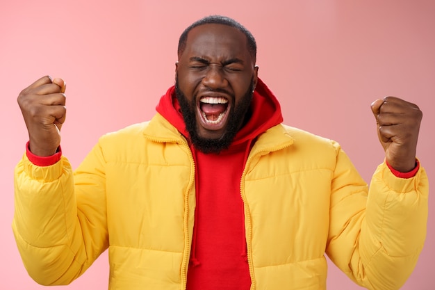 Man with a red sweatshirt over pink