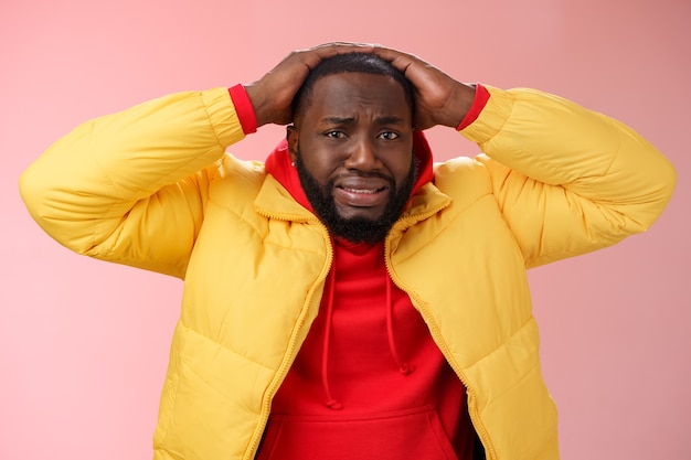 Man with a red sweatshirt over pink