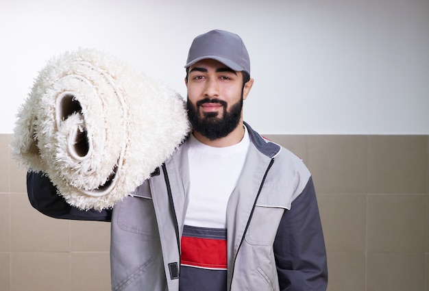 Man with a roll of carpet