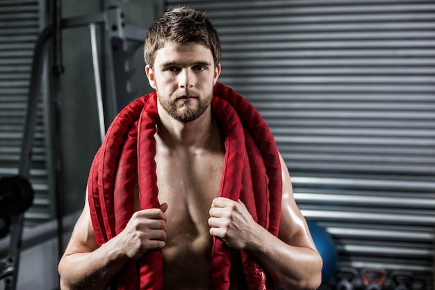 Man with rope around his neck at crossfit gym