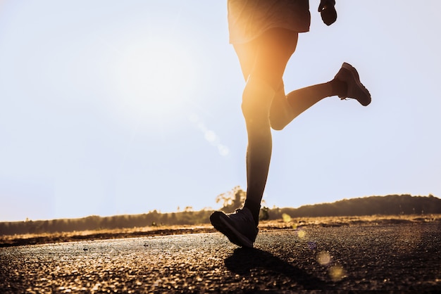 The man with runner on the street be running for exercise.