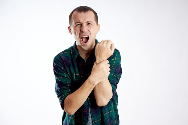 Man with sharp pain in the arm elbow isolated