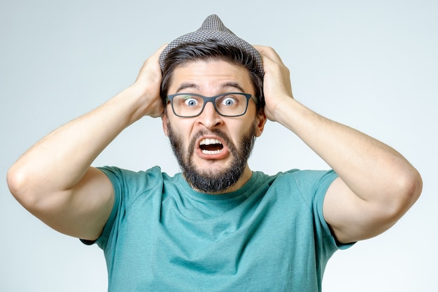 Man with shocked, amazed expression isolated on gray background