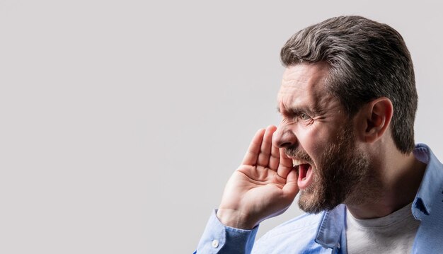 Photo man with shouting face isolated on studio background copy sace banner man with shouting face