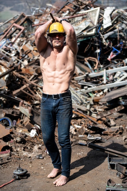 Man With Six Pack in Old Scrap Metal Garage