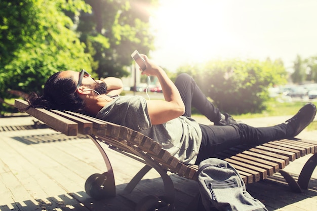 Photo man with smartphone and earphones listening music