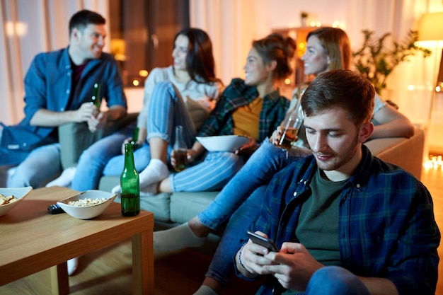 man with smartphone at home party